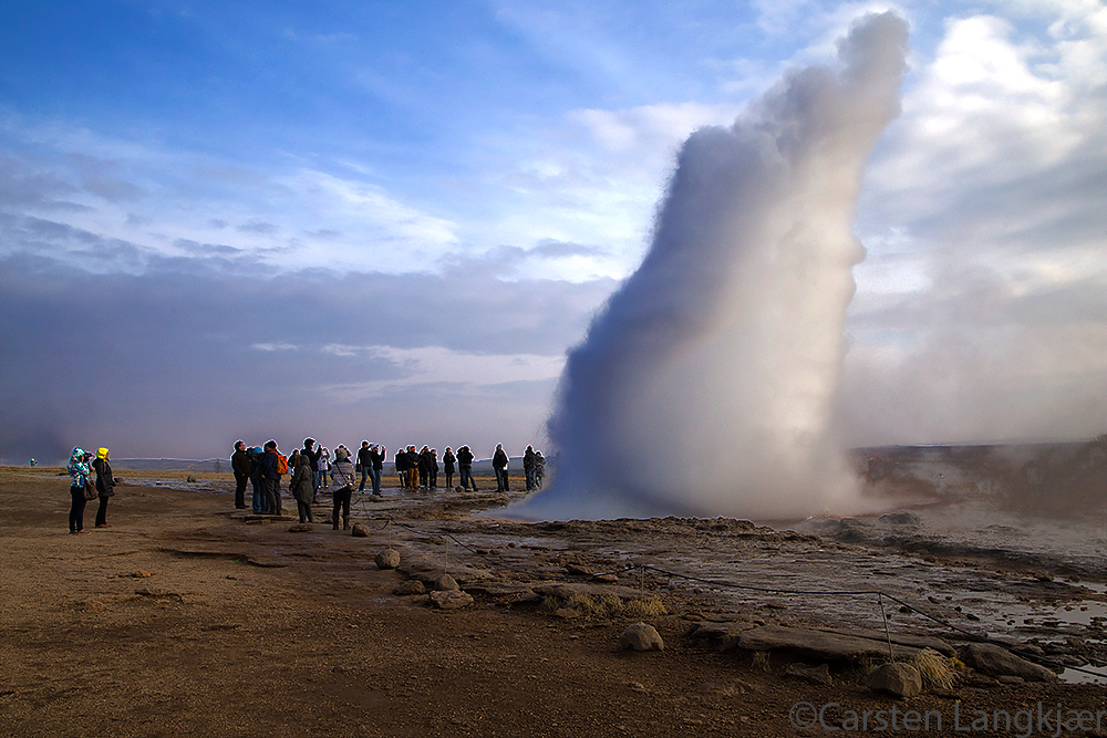 Stokkur is blowing steam and boiling water frequently. Compare with the people for scale.